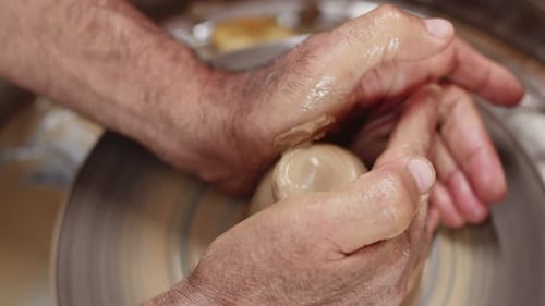 Hands Shaping Clay on Pottery Wheel Close Up