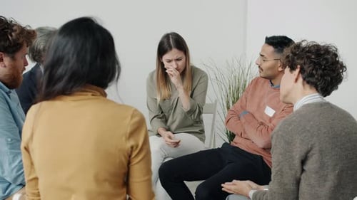 Woman Crying in Therapy Session Receives Support