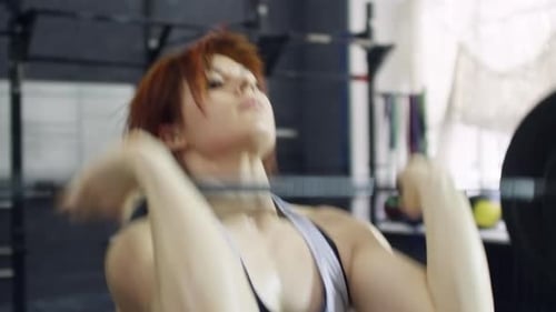 Female Weightlifter Doing Overhead Press