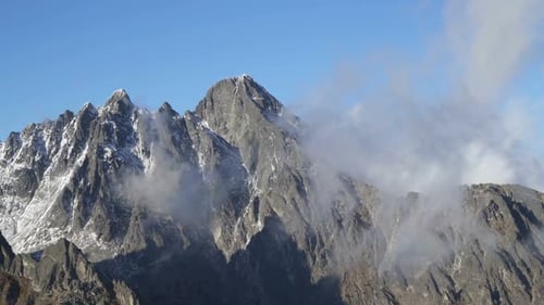 Clouds in Rocky Alps Mountains