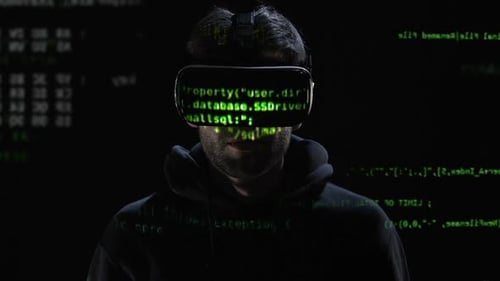 Man Wearing VR Headset Surrounded by Projected Code