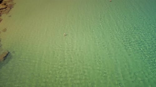 Aerial view of people enjoying a public beach in Greece.