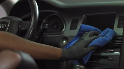Dry Cleaning the Car Interior Closeup of an AfricanAmerican Man Wiping the Car's
