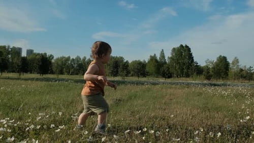Slow Motion of a Small Child Running Through the Park