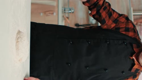 Vertical Video: Bakery Man Sifting Flour, Preparing Bread Dough
