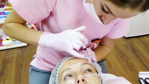 Aesthetician Injects Serum Into Woman's Forehead