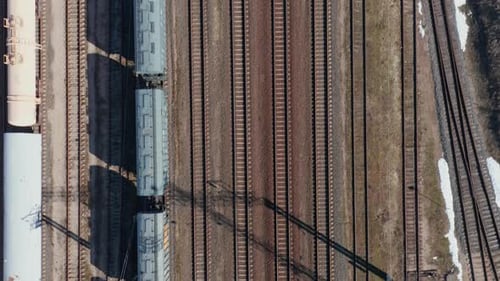 AERIAL: Top Down View of Empty Cargo Train Parked on Train Rails