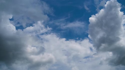 Clouds Slowly Drifting Across Vivid Blue Sky