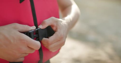 Close Up Securing Life Vest Before Water Activity