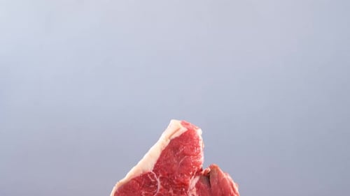 Raw meat and parsley on wooden table