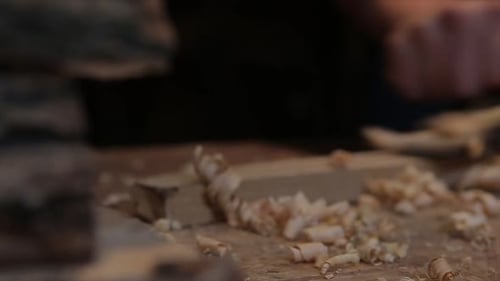 Woodworker Using Hand Plane on Wood Close Up