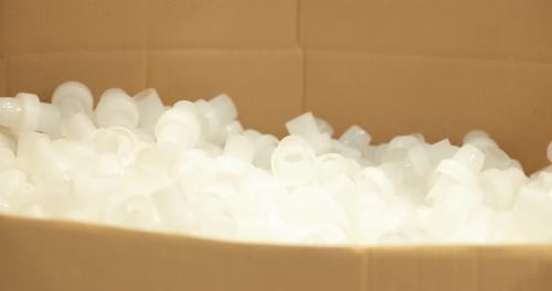 Finished Plastic Products Dropping Into A Carton Box For Packaging. Injection Molding Company. close