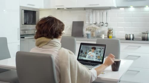 Woman Telehealth Appointment in Modern Kitchen