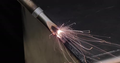 Welding Torch with Bright Sparks Close Up