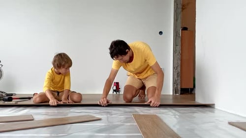 Father and Son Laying Laminate Floor Together