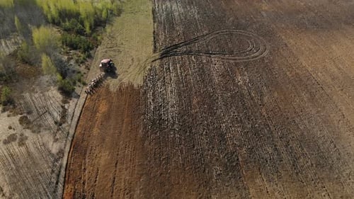 Tractor Cultivates the Land, Plowing the Field