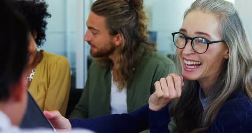 Engaged Colleagues Discussing Business in Office