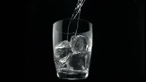 Pouring water into glass, Slow Motion