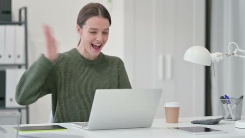 Woman Working and Smiling on Laptop