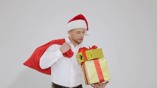 Young Man with Santa Hat Holding Gifts
