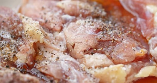 Add black pepper, salt and oil into raw chicken thigh