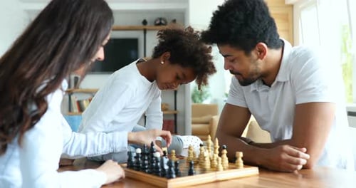 Family Playing Chess Together at Home