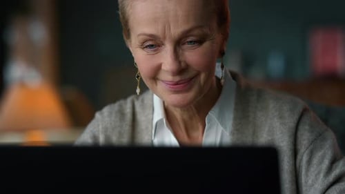 Portrait of Sentimental Old Woman Looking Computer Screen in Luxury Interior