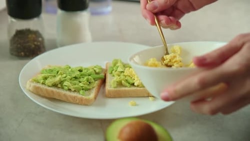 Preparing Healthy Avocado Toast with Scrambled Eggs