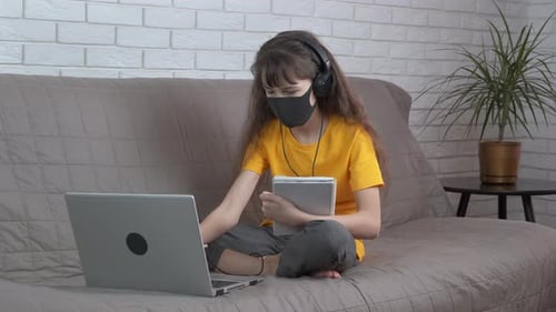 Child Doing Online Schoolwork on Laptop at Home