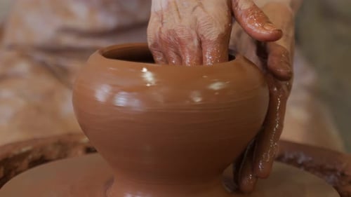 Hands Shaping Clay on Potter's Wheel