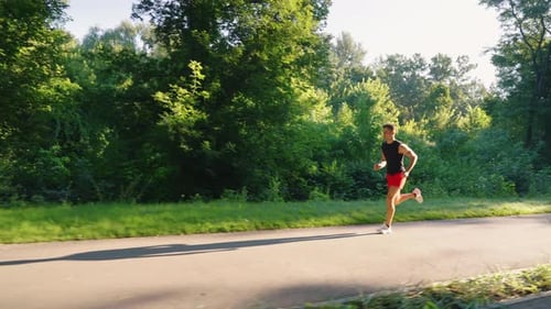 Slow Motion Runner Exercising in Park