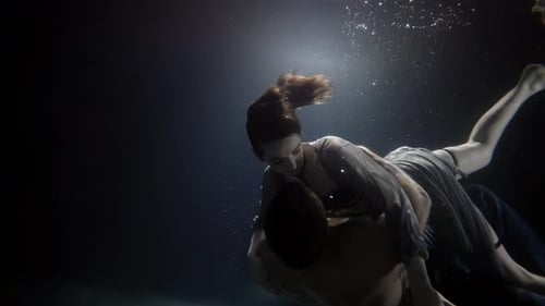 Romantic Couple Underwater in Dark Environment