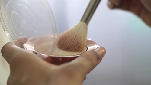 Makeup Brush Applying Cosmetics in Compact