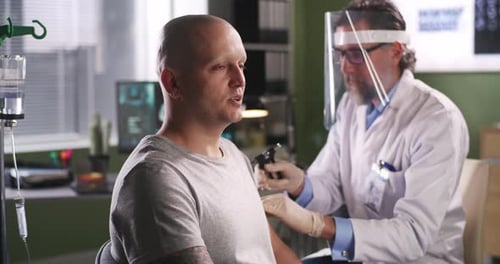 Doctor Examines Patient With Medical Equipment in Office