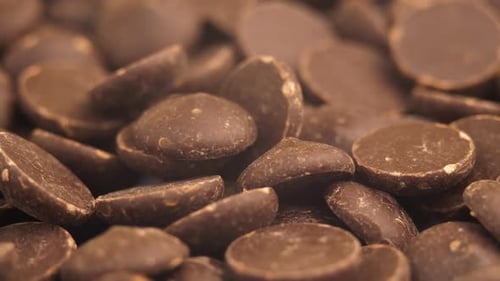 Chocolate Chips Drops Rotating Background. Food Concept. Unhealthy Sweets Backdrop