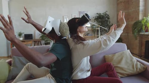 Couple Experiencing Virtual Reality Together in Living Room