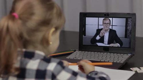 Child Learning Online with Teacher on Laptop