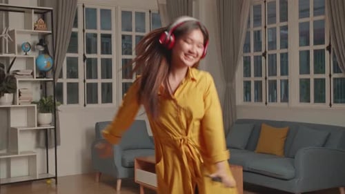 Energetic Woman Dancing and Singing at Home
