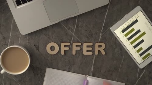 Wooden Letters Spell Offer On A Workplace Table