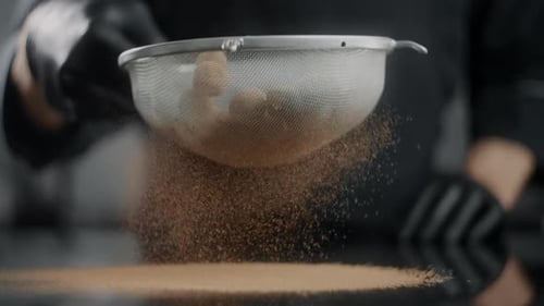 Close Up of Sifting Cinnamon Powder with Sieve