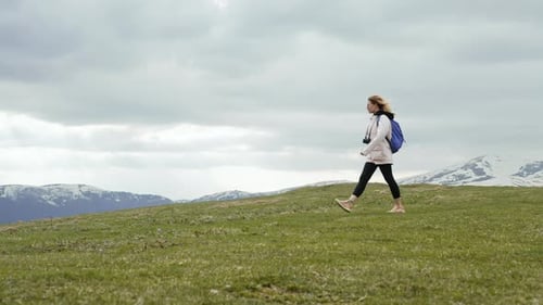 Young Traveller Woman Walking Alone on Valley of High Mountain