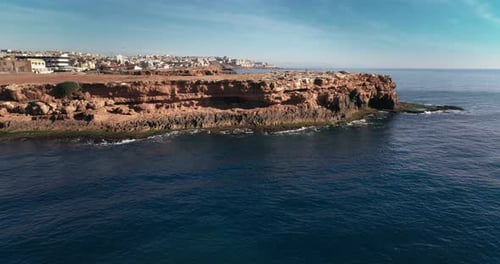 Drone Approaches to the Rocks and Overlooks the Calm Sea Water Rocky Coastline