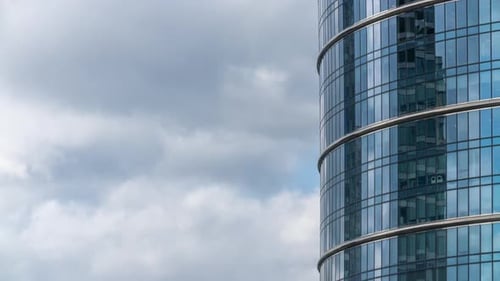 Timelapse Glass Skyscraper High Office Building Facade Blue Sky and Clouds Moving Fast Reflected on