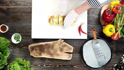 Hands of Chef Cutting Burrito