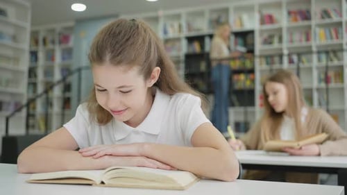 Girl Reading Funny Book in Class and Laughing