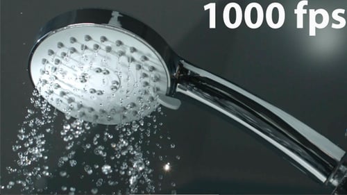 Close Up Shower Head With Water Drops Splashing Out And Running From Faucet In Bathroom Flowing