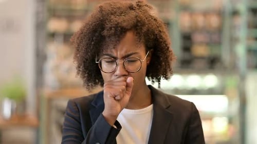 Woman Coughing into Fist, Close Up Studio Shot