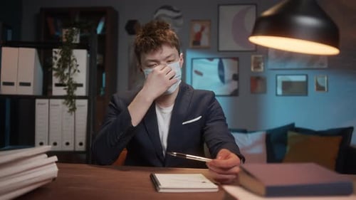 Young Adult at Desk Wearing Face Mask
