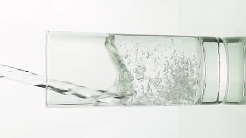 Clear Water Being Poured into Glass Cup