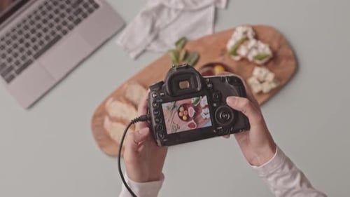 Food Photographer Reviewing Pictures on Camera